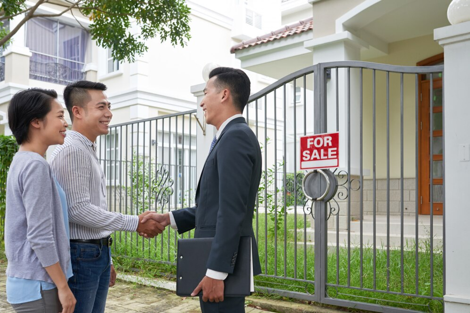 Couple Meeting With Real Estate Agent